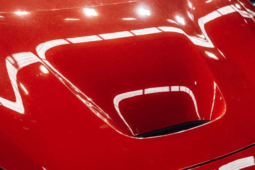 Exhaust on the hood of a red sports car